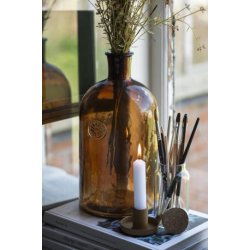 Apotekerflaske med blomsteremblem